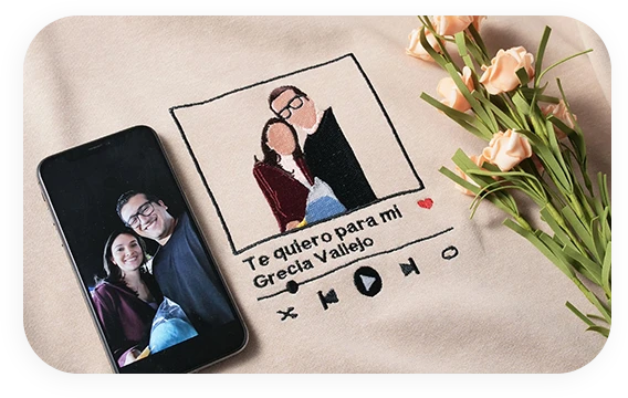 Personalized photo-to-embroidery service on a hoodie featuring a couple's portrait and music player design.