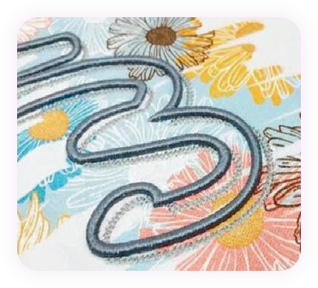 Artistic floral embroidery combined with thick rope-style outlines for a textured 3D effect.