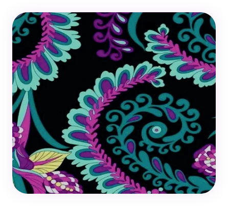 Highly detailed paisley embroidery pattern in purple and teal on a black fabric background.