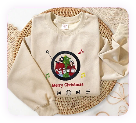 Custom Christmas-themed sweatshirt with a music player design and embroidered holiday portrait.